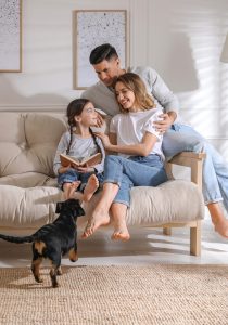 Family laughing on couch